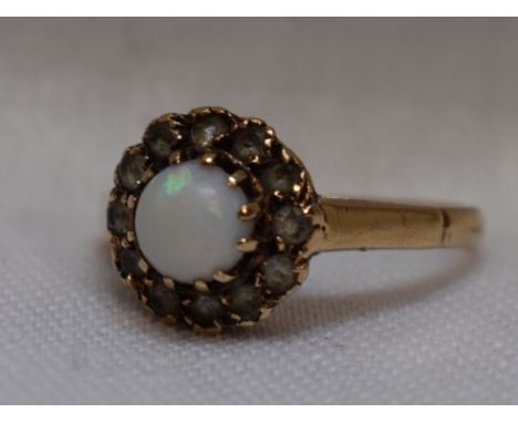 A lady's dress ring having an opal and cubic zirconia cluster on a 9ct gold loop, size N
weight 2.5g