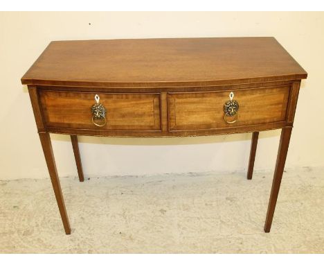 A MAHOGANY SIDE TABLE, 19th century, of bowed form with plain and chequer stringing, two deep banded frieze drawers with bras