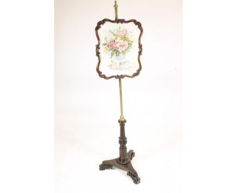 GILLOWS OF LANCASTER, a William IV Goncalo Alves Pole Screen, the shield shaped floral needlework screen within a carved scro