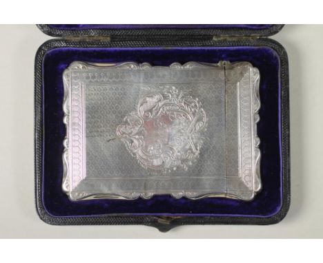 A VICTORIAN SILVER VISITING CARD CASE, maker's mark CC, Birmingham 1873, of shaped oblong form with hinged cover, the fascia 