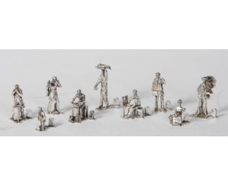 A SET OF NINE NOVELTY SILVER MENU HOLDERS, maker Thomas Charles Jarvis, London 1977 (x1) and 1986, cast as figures plying the
