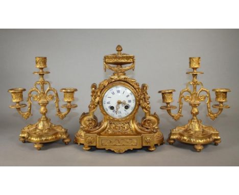 A FRENCH GILT METAL CLOCK GARNITURE, the twin barrel drum striking movement with backplate stamped G. Schimall, Paris, 3 1/4"