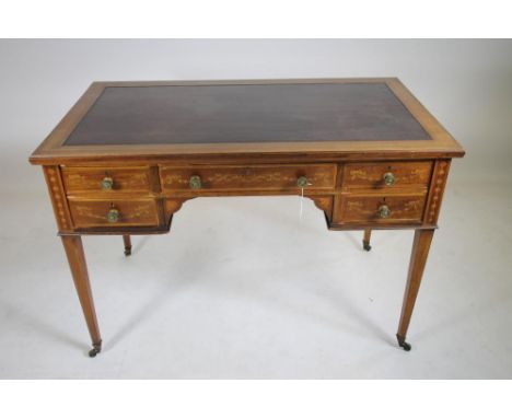 JAMES SHOOLBRED & CO., LONDON, an Edwardian mahogany library table crossbanded with stringing and with inlaid ribbon tied flo