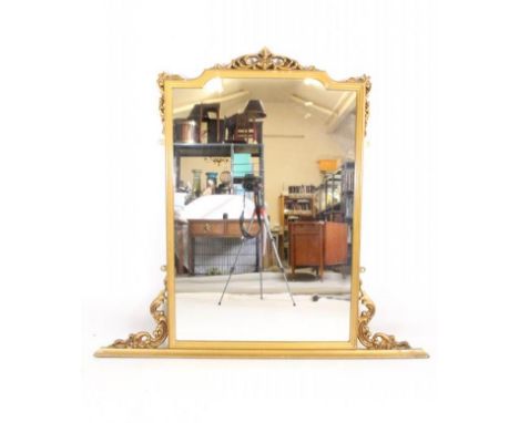 A VICTORIAN CARVED GILT WOOD OVERMANTEL MIRROR, the arched oblong plate within a moulded surround with pierced scroll surmoun