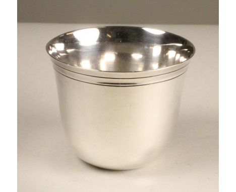A CONTINENTAL TUMBLER CUP, probably Austro-Hungarian, of typical form with a pair of engine turned bands to the rim, 2" high,