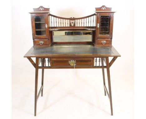 SHAPLAND & PETTER, BARNSTAPLE, a mahogany desk, the rexine inset top with mirrored back with shelf and spindle gallery over a