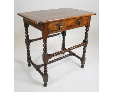 A CHARLES II FRUITWOOD SIDE TABLE, the oblong cleated top over frieze drawer with brass drop handles, raised on bobbin turned
