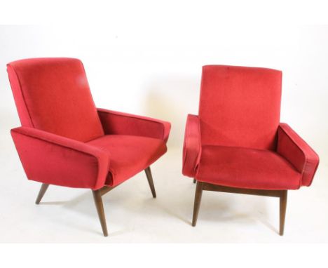 A PAIR OF TEAK FRAMED ARMCHAIRS, 1960's, upholstered in red dralon, straight top rail, sloping square section arms, raised on