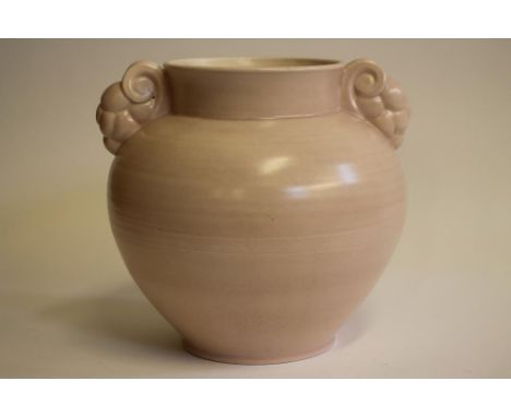 A POOLE POTTERY VASE, 1950's, of lightly ribbed baluster form with stylised scroll and grape lug handles in "Pastel Pink" gla