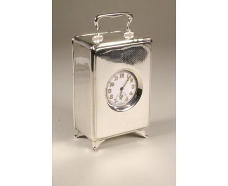 A SILVER CARRIAGE TIMEPIECE, maker's mark C & ?, Birmingham 1920, of plain oblong form with hinged handle, the fascia with en