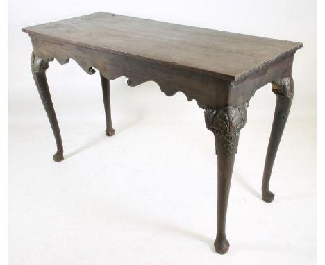 A GEORGIAN MAHOGANY SIDE TABLE, possibly Irish, mid/late 18th century, of oblong form with scroll edged frieze, raised on cab