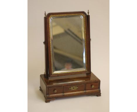 A SMALL GEORGIAN MAHOGANY TOILET MIRROR, mid 18th century, the arched bevelled plate within a moulded and parcel gilt surroun