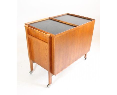 NIELS ERIK GLASDAM JENSEN, a Danish teak framed "bar-cart", of oblong form and dividing into two sliding sections each with c