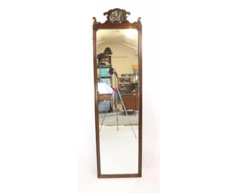 A GEORGIAN MAHOGANY FRET PIER GLASS, the oblong plate within a mildly arched moulded and parcel gilt surround, scrolled arche