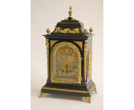 AN EBONIZED AND GILT METAL MOUNTED TABLE CLOCK of Georgian design, late 19th century, the twin barrel movement striking on a 