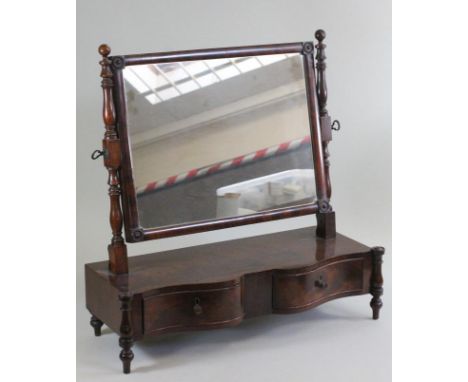 A WILLIAM IV MAHOGANY TOILET MIRROR, the oblong plate within a cushion frame with corner roundels hung from baluster turned u