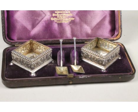 A PAIR OF VICTORIAN SILVER SALTS, makers Henry Wilkinson & Co., Birmingham 1882, of plain square section with bead stamped bo