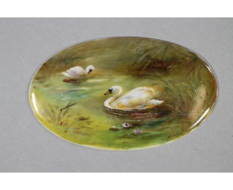 A ROYAL WORCESTER CHINA SMALL PLAQUE, c.1916, of oval form, painted in colours by James Stinton with a pair of swans swimming