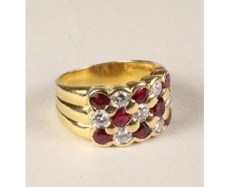 A RUBY AND DIAMOND RING, the chequerboard plaque set with eight rubies and seven diamonds to a reeded 18kt gold shank, size N