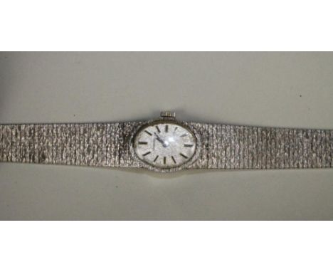 A LADY'S SILVER "LONGINES" WRISTWATCH, the matt oval dial with applied line batons on an integral articulated brushed bark ef