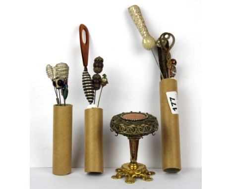 A pin stand and a collection of hat pins.