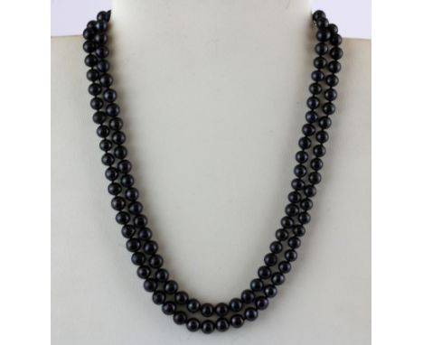 A vintage necklace of black cultured pearls with a  white porcelain decorated clasp, pear size 6mm.