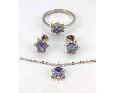 A matching suite of 925 silver ring, pendant and earrings set with cabochon cut tanzanite and white stones, dia. 0.8cm, (R.5)