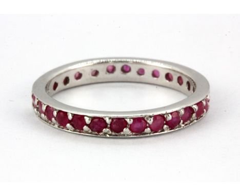 A 925 silver ruby set full eternity ring (O).