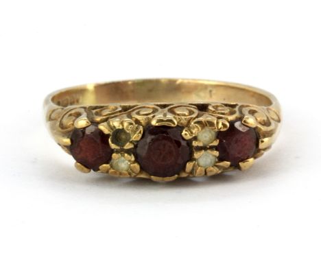 A 9ct yellow gold garnet and white stone set ring, (R.5) (one stone missing).