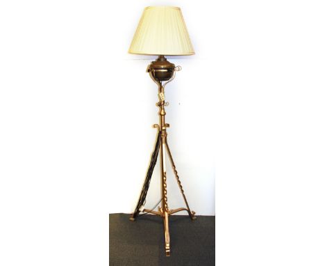 A Victorian wrought iron oil lamp stand converted to an electric standard lamp, H. 151cm.