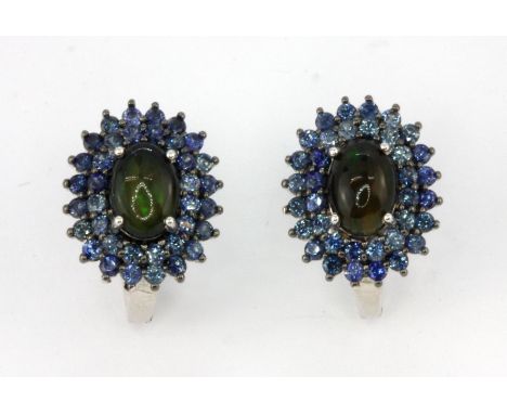 A pair of 925 silver cluster earrings set with a black cabochon cut opal surrounded by two rows of round cut sapphires, L. 1.