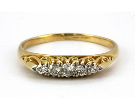 An 18ct yellow gold (work stamp) ring set with five graduated old cut diamonds, (R).