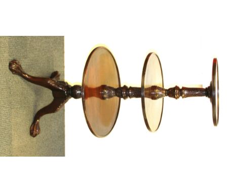 A Georgian mahogany three tier buffet/ cake stand on eagle claw feet, H. 126cm Dia. 60cm.