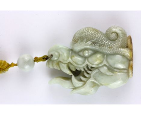 A superb 19th Century Sino-Tibetan carved jade protective amulet with Tibetan yellow silk carrying cord, jade size 7 x 5 x 2c