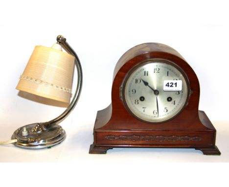 A mantle clock and a vintage chrome reading light.