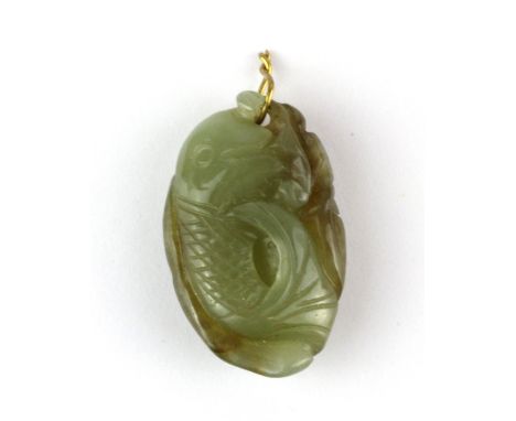 A small antique Chinese carved nephrite jade amulet of a fan tailed fish, H. 3cm.