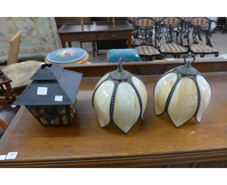 A pair of hanging light shades and a lantern style hanging light