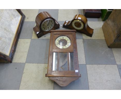 An oak wall clock and two mantel clocks
