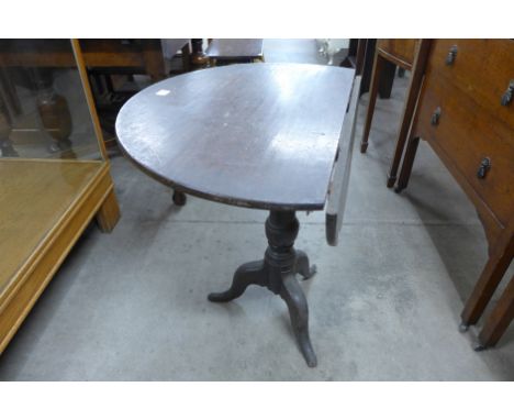 A George III oak circular tilt top tripod table