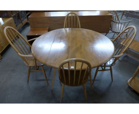 An Ercol drop leaf table and four chairs