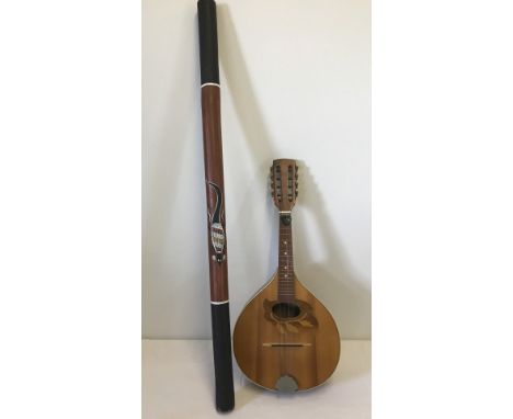A vintage wooden Mandolin together with a Didgeridoo with tribal decoration. Mandolin is labelled Made in Romania, Reghin. Di