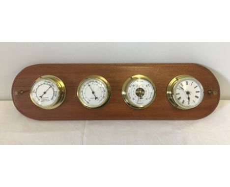 A modern set of Nautical gauges mounted on a wooden plinth. Comprising; hygrometer, thermometer, barometer and clock. With sc