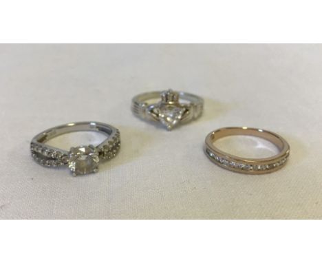 3 silver rings set with CZ stones. 1) Claddagh ring set with heart shaped stone, approx size Q. 2) Solitaire with stone set s