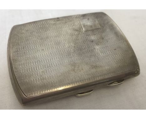 An Art Deco silver cigarette case with engine turned decoration to front and back. Empty square cartouche to front. Hallmarke