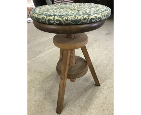 A vintage pine screw top adjustable stool with 3 legs. Complete with green upholstered cushion. 