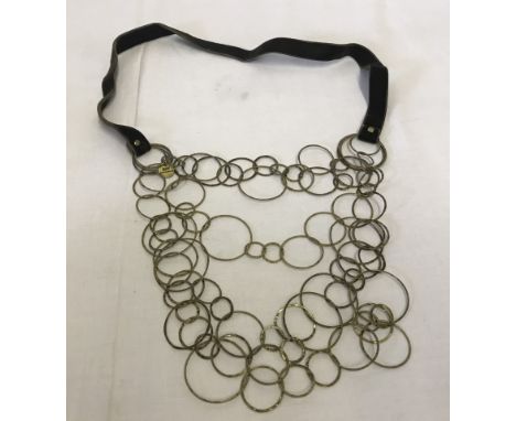 A designer necklace by Day Birger et Mikkelsen. Large statement necklace with interlinked gold coloured rings on 6 levels. Fi