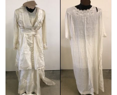 A 1915 Edwardian Silk wedding dress with long sleeves and silk covered button to front. Lace detail to sleeves and bottom edg