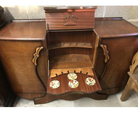 A vintage medium wood side board with central cocktail cabinet. Compete with original cocktail sticks. Circa 1950's. Approx. 