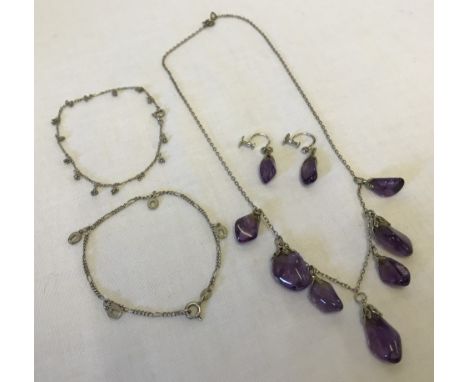 A silver necklace with 7 amethyst pendants and matching silver & amethyst earrings. The earrings have screw fittings.  Togeth