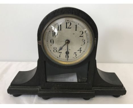 A small dark wood cased Napoleon hat mantel clock with bevel edged glass panel. Complete with key and pendulum. Approx. 32cm 